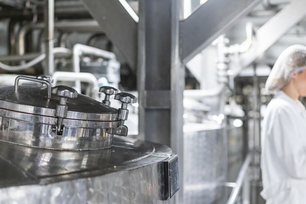 Working with industry machinery at a dairy factory stock photo